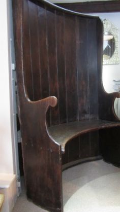 a wooden bench sitting in front of a mirror