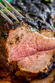 a piece of meat is being cut by a fork