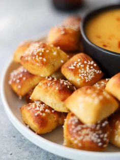 small pastries on a plate with dipping sauce