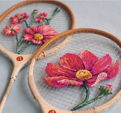 two tennis racquets decorated with flowers on them