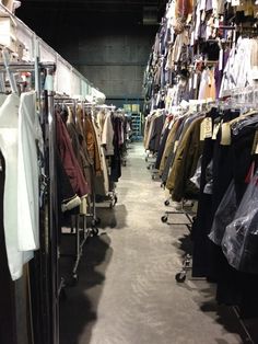 a room filled with lots of clothes on display