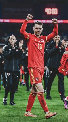 the soccer player is celebrating his team's victory in front of fans on the field