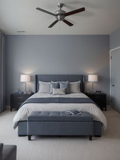 a bedroom with a large bed and ceiling fan