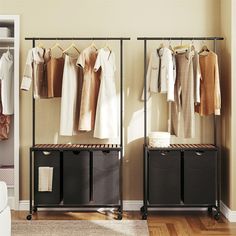 an organized closet with clothes hanging on racks and storage bins next to the door