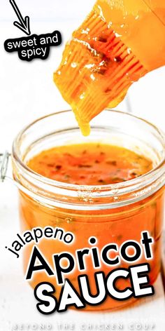 a jar filled with apricot sauce being drizzled over the top