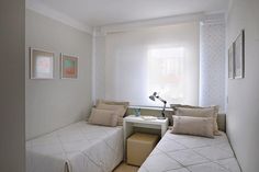 two beds in a small room with white walls