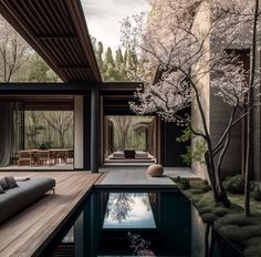 an outdoor living area with a pool surrounded by trees