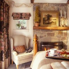 a living room filled with furniture and a fire place in front of a painting on the wall