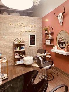 a hair salon with brick walls and wooden flooring, including a chair in front of the mirror