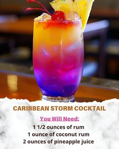 a colorful cocktail with pineapple on the rim