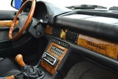 an interior view of a car with wood trim and dash board, steering wheel and dashboard