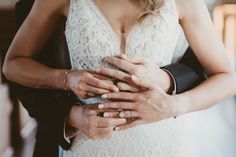 a bride and groom holding each other's hands