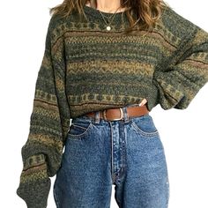 a woman is wearing a sweater and jeans