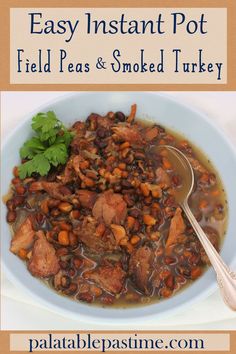 a bowl filled with meat and beans next to a spoon