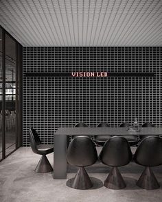 a dining room table with four chairs and a sign that reads vision led above it