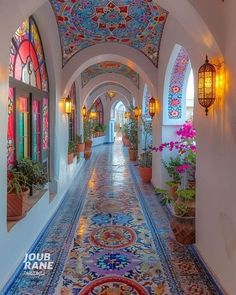 an arched hallway with colorful tiles and potted plants on either side, surrounded by stained glass windows