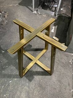 a wooden bench sitting on top of a cement floor