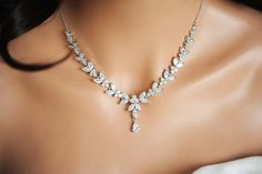 a woman wearing a diamond necklace on her neck