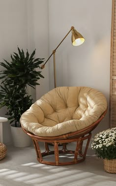 a living room with a chair, lamp and potted plant