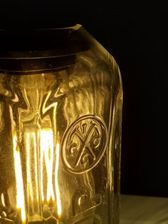 a close up of a glass jar with some lights in it on a table top