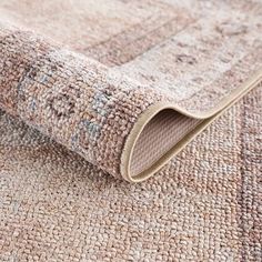 a close up view of a rug with an area rug on the floor that looks like it is made out of wool