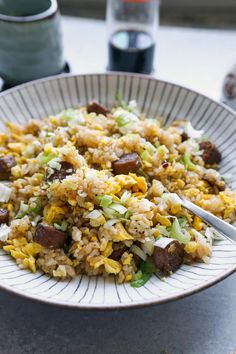 a white plate topped with rice and sausage