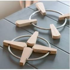 four wooden pieces are connected to each other on a table