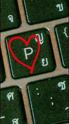 a keyboard with a red heart on it