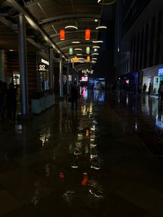 people are walking in the rain at night