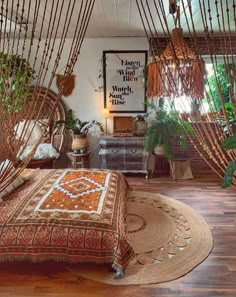 a bedroom with lots of plants in the corner and hanging from the ceiling over the bed