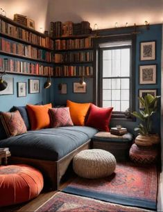 a living room filled with lots of furniture and bookshelves full of books on the wall