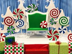 a green chair surrounded by presents and candy canes