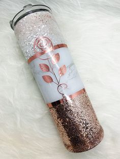 thermos cup is decorated with roses and glitters on it's side