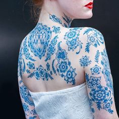 a woman with blue tattoos on her body