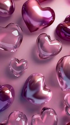 many shiny hearts are arranged on a pink background