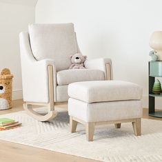 a white chair with a teddy bear sitting on it's back in a living room