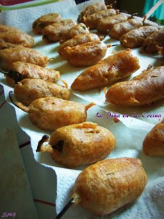 breads and pastries are lined up on white paper