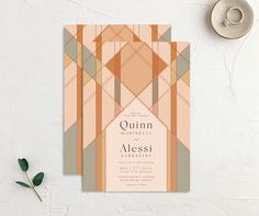 a wedding card with an abstract geometric design