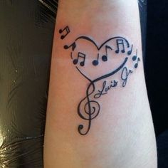 a heart with musical notes on it and the word love is written in black ink