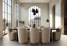 a dining room table surrounded by beige chairs