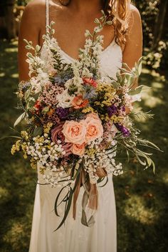 a woman holding a bouquet of flowers in her hands