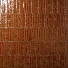 a close up view of a brown tile wall