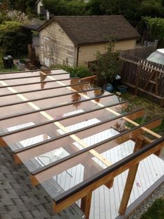 an overhead view of a house with wooden slats on the roof and glass windows