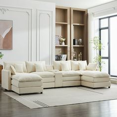 a living room with a large white sectional couch