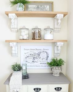 some shelves with plants and candles on them