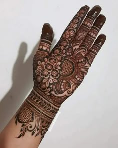 the hand is decorated with henna designs