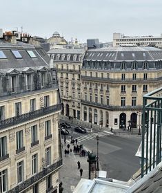 an aerial view of some buildings and people walking down the street in paris, france