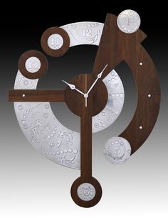 a clock made out of metal and wood with white designs on it's face