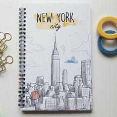 a notebook with the new york city skyline drawn on it