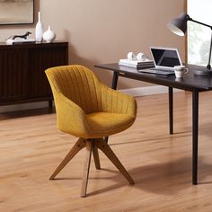 a yellow chair sits in front of a desk with a laptop on it